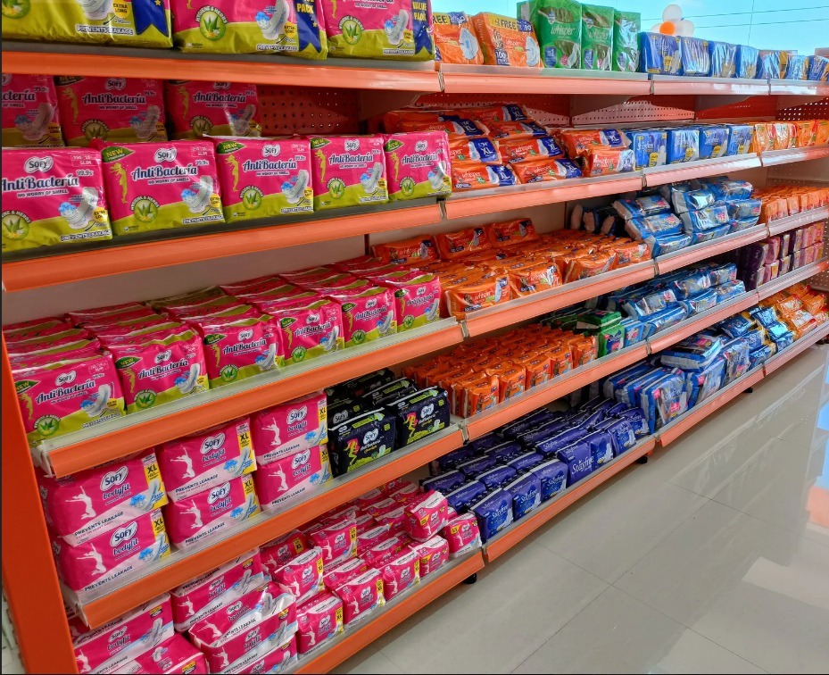 Shelves stocked with premium tea bags, loose tea powder packets, and instant coffee brands